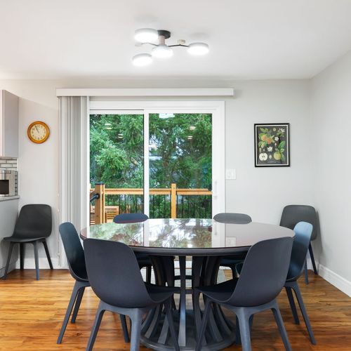 Enjoy meals in the spacious dining area, just steps away from a modern, fully equipped kitchen.