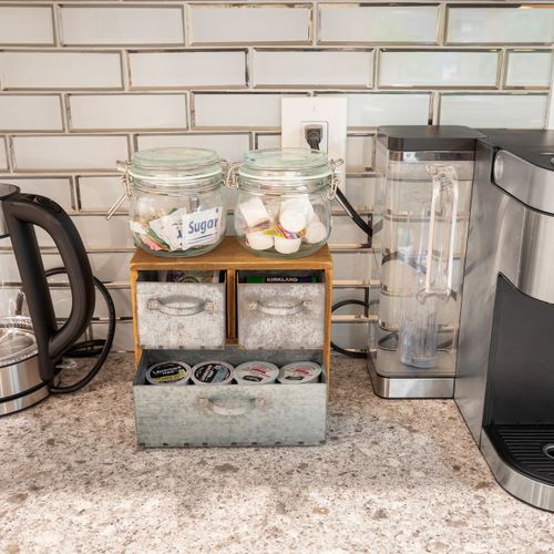 The kitchen features a Keurig coffee maker, complete with coffee, sugar, and cream to help you start your day with ease.