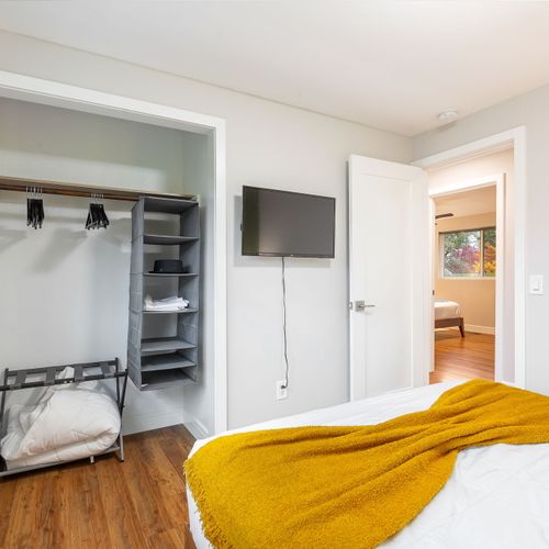 This inviting bedroom offers a roomy closet and a wall-mounted TV for the ultimate in comfort and convenience.