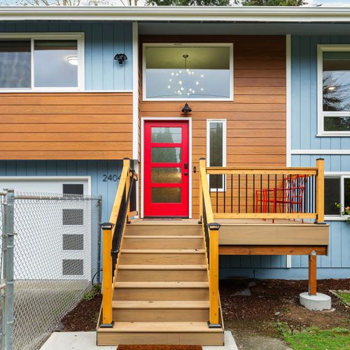 Welcome to Seattle! The vibrant red door leads the way, offering a cheerful entrance to this charming home.