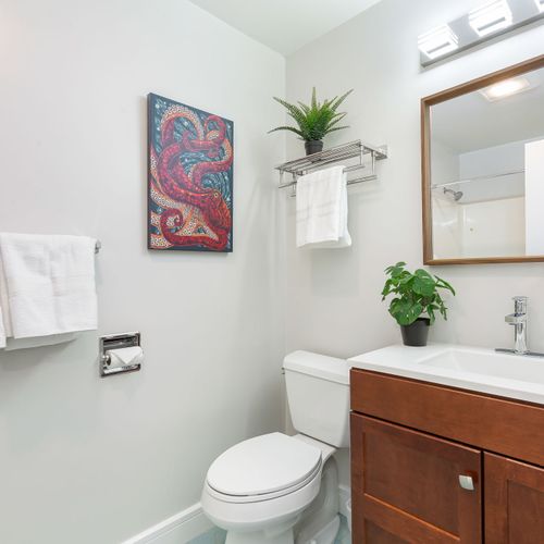 The bathroom is designed with modern fixtures and plenty of space.