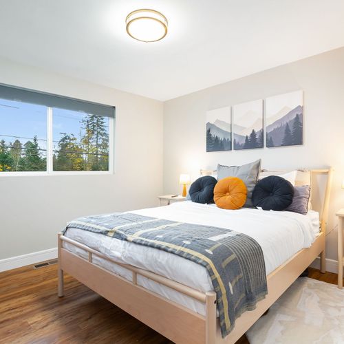 Bedroom with a window that not only adds to the room’s brightness but also offers scenic views of the outdoors.