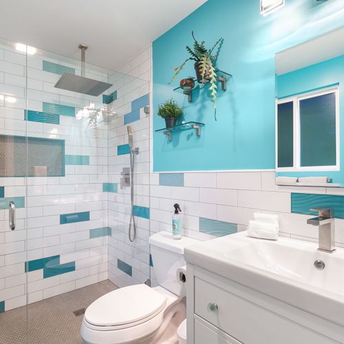 With its cool blue tones and contemporary design, this bathroom blends modern elegance with calming vibes.