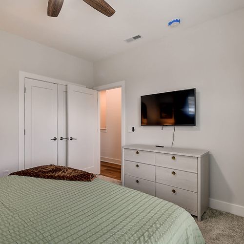 Skyline view bedroom with King bed including a TV and dresser for your comfort and convenience.