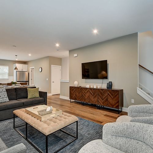 This open floor plan connects the kitchen, dining, and a modern living room, making it easy to enjoy company.