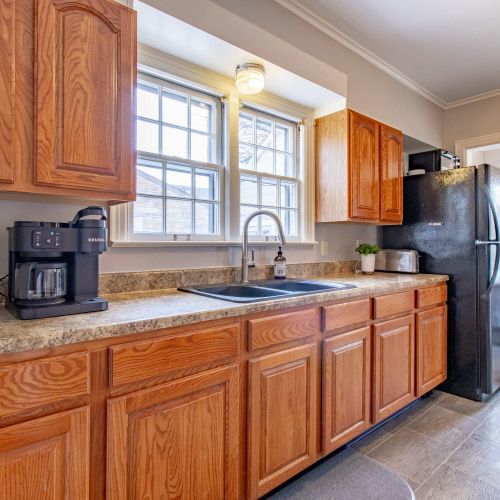 A charming kitchen awaits, complete with a Keurig and a selection of coffee pods ready to brew your perfect cup. Start your day with the aroma of fresh coffee and savor your morning in this cozy spot.