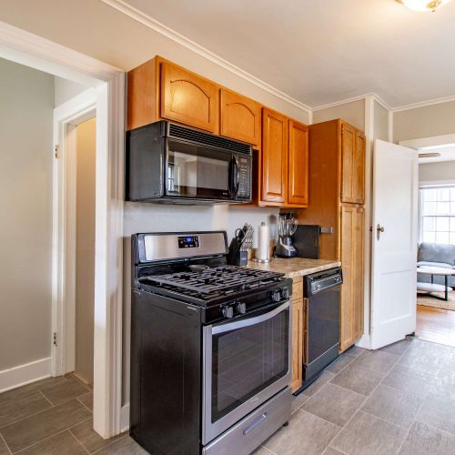 A fully equipped kitchen featuring modern countertops and appliances, perfect for cooking and baking. Leading downstairs to two of your bedrooms!