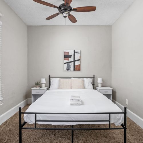 Relax and unwind in this first bedroom with a full bed, nightstands and lamps for your convenience.