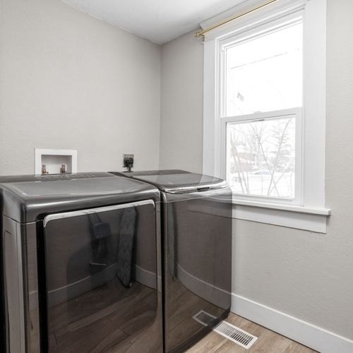 A washer and dryer just off of the kitchen, complete with an ironing board and iron for your convenience.