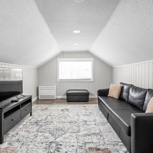 Upstairs leads into a loft with a full size couch, smart TV and ample space for family or group conversations!