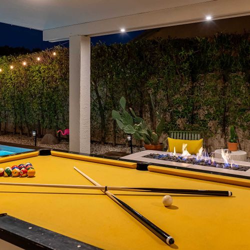 Outdoor billiards table and fire pit area