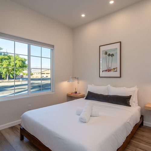 Bedroom 6 with queen bed (Please note: Bedroom 6 is a garage-to-bedroom conversion with a full bathroom. This bedroom has a separate entrance attached to the home and is only accessible from the exterior)