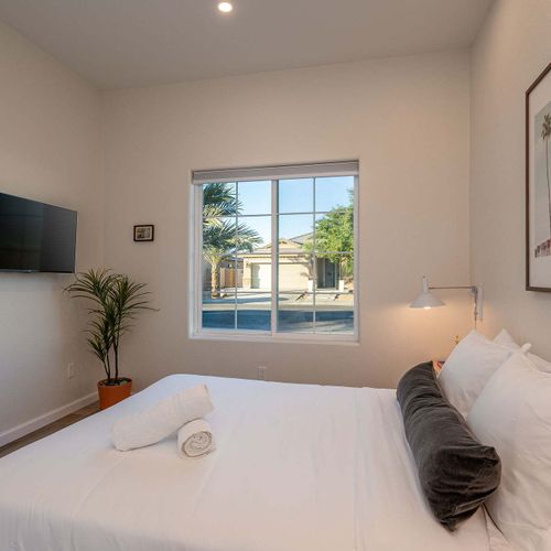 Bedroom 6 with flatscreen TV (Please note: Bedroom 6 is a garage-to-bedroom conversion with a full bathroom. This bedroom has a separate entrance attached to the home and is only accessible from the exterior)