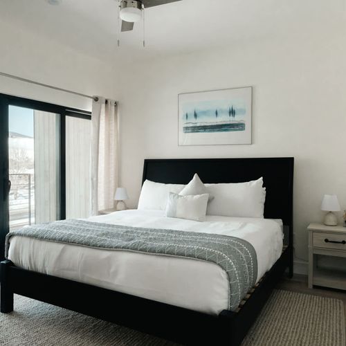 Primary bedroom with king bed and private balcony