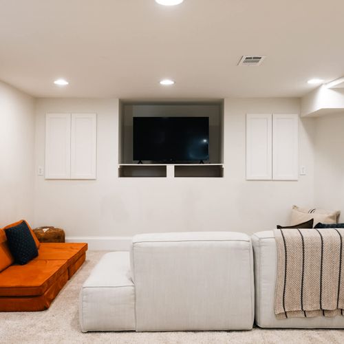 Basement living area with TV and seating
