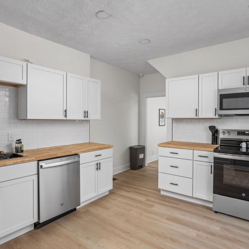 Step inside the modern renovated kitchen! Complete with new cabinets, backsplash, butcher block counters, and sparkling new appliances!