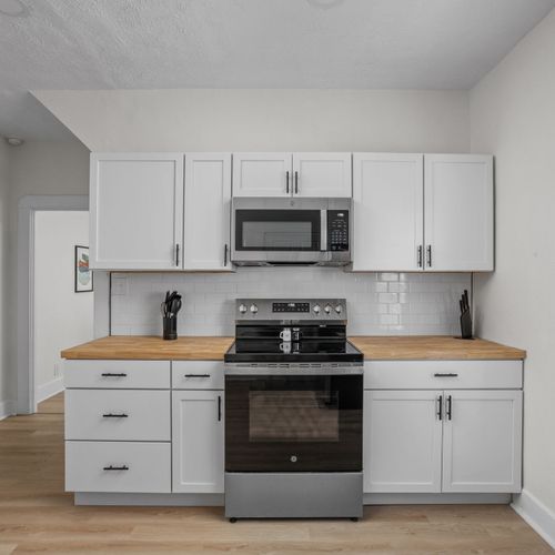 Step inside the modern renovated kitchen! Complete with new cabinets, backsplash, butcher block counters, and sparkling new appliances!