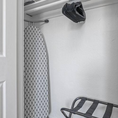 Inside the closet features an iron, ironing board, luggage rack, and hangers all for your convenience!