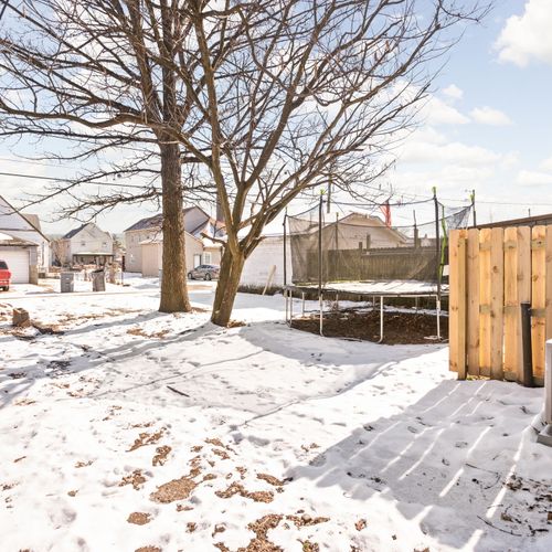 Backyard featuring a parking pad and walkway to the backdoor.