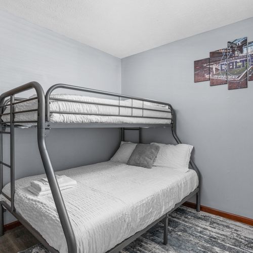 Our bunk room features a twin and full bed, night stands, and Indianapolis decor!