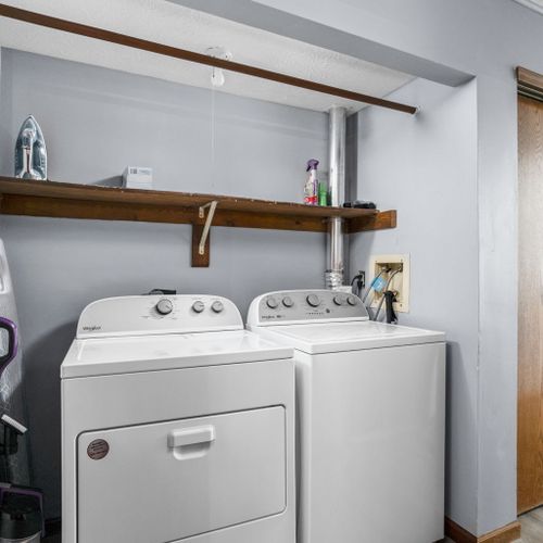 This laundry area features an iron and ironing board, ample detergent and dryer sheets to get your started on your stay!