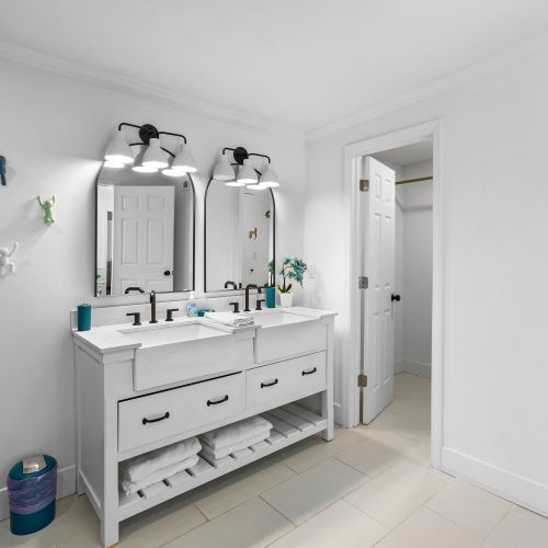 Mid century modern bathroom with natural light, terrazzo floors and marble on the walls and shower.