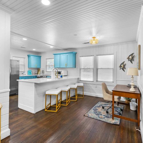 Fully renovated and fully equipped kitchen featuring elegant marble countertops and spacious cabinets to accommodate all your family's needs. Plus, a dedicated workstation for a seamless workcation experience.