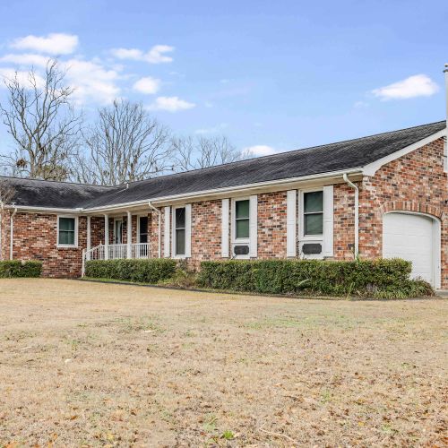 Spacious brick home with a two-car garage, a large driveway with plenty of parking, and ample outdoor space—ideal for a peaceful and comfortable stay!