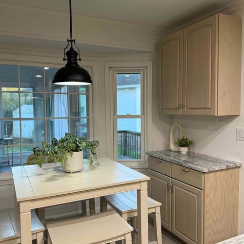 A cozy kitchen nook with a dining table, stylish lighting, and a view of the outdoors—perfect for enjoying meals or a morning coffee.