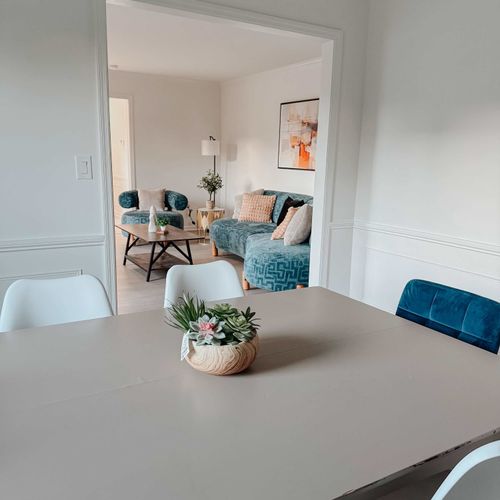 An inviting dining area that flows into a cozy living space, creating a comfortable setting for meals and relaxation.