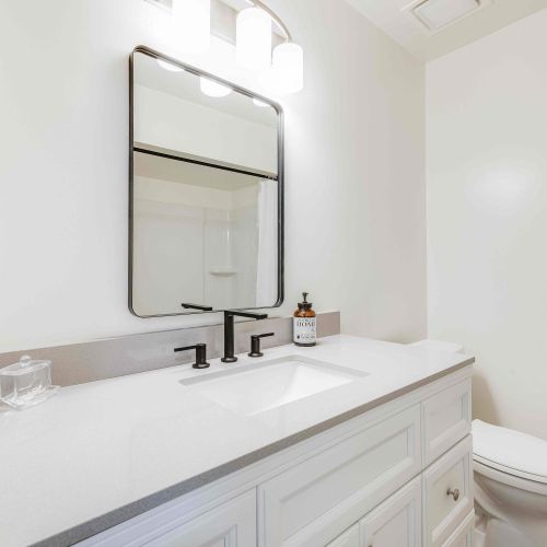 Bathroom 2 offers a clean and modern space with a stylish vanity, bright lighting, and a spacious shower—perfect for refreshing and unwinding.