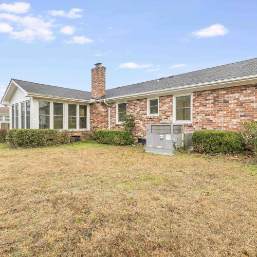 The backyard offers a spacious, fenced-in outdoor area with a charming brick exterior, a chimney, and a sunroom—perfect for relaxing and enjoying the outdoors. Plus, it's pet-friendly!