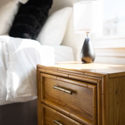 Bright and inviting bedroom with a cozy bed, stylish decor, and a sleek wooden nightstand — perfect for a comfortable stay!