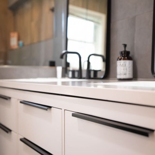 Contemporary bathroom featuring dual vanity mirrors, double sinks, and sleek black fixtures — designed for comfort and style.