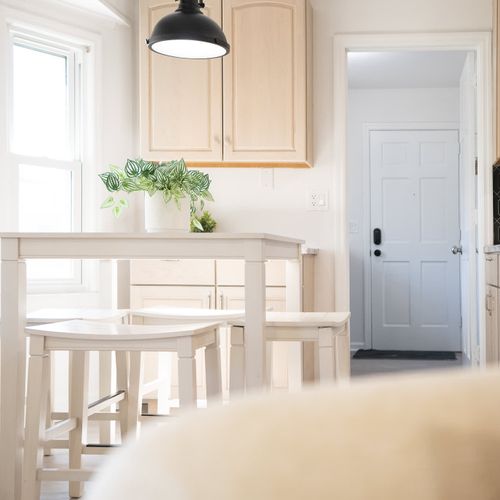 Sunlit kitchen with a chic dining set and modern accents — where every meal feels like a special occasion.