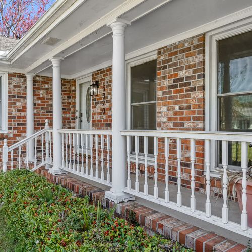 Charming brick home with a classic front porch, perfect for relaxing and enjoying the outdoors. 🏡