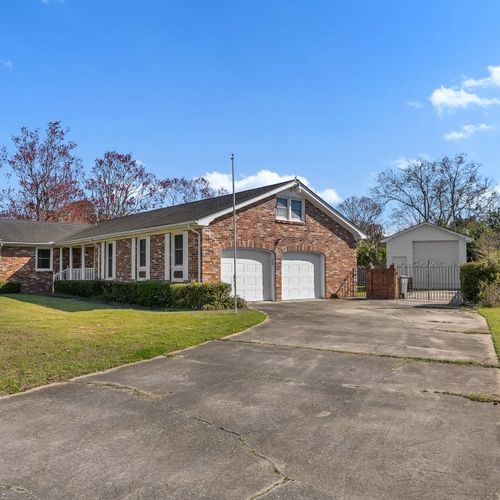 Large driveway and lush yard — a perfect blend of comfort and charm.