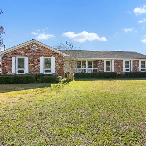 Spacious brick home with classic charm, a large front yard, and inviting curb appeal — perfect for your next getaway!