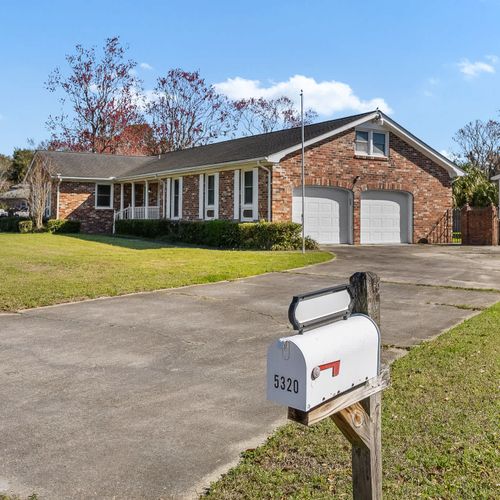 Spacious brick home with a two-car garage, a large driveway with plenty of parking, and ample outdoor space—ideal for a peaceful and comfortable stay!