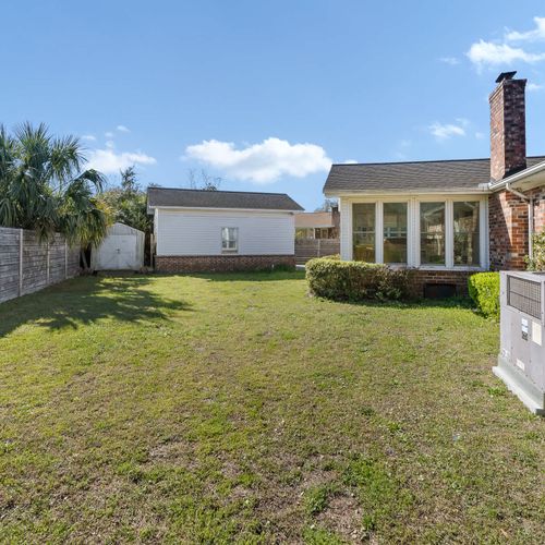 The backyard offers a spacious, fenced-in outdoor area with a charming brick exterior, a chimney, and a sunroom—perfect for relaxing and enjoying the outdoors. Plus, it's pet-friendly!