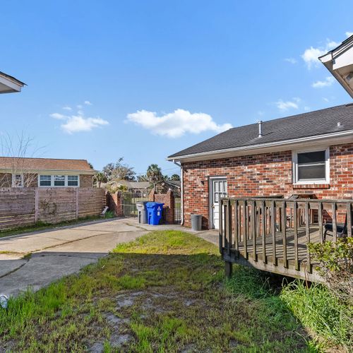Private backyard space with a cozy deck and ample room for outdoor gatherings.