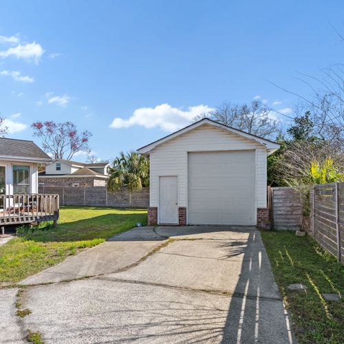Spacious backyard with a private garage and deck.