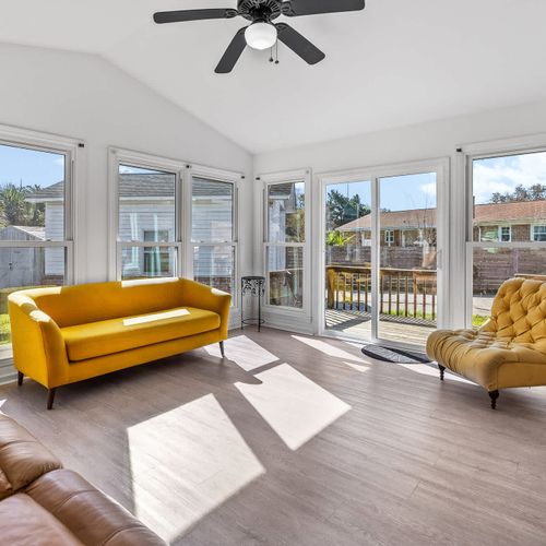 Bright and inviting sunroom with stylish seating and backyard views — your perfect spot to relax and unwind.