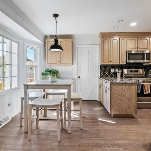 Bright and inviting kitchen with modern appliances and cozy dining — the perfect space to enjoy meals.