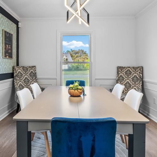 Elegant dining space with stylish decor and a serene backyard view—perfect for enjoying meals or a morning coffee.