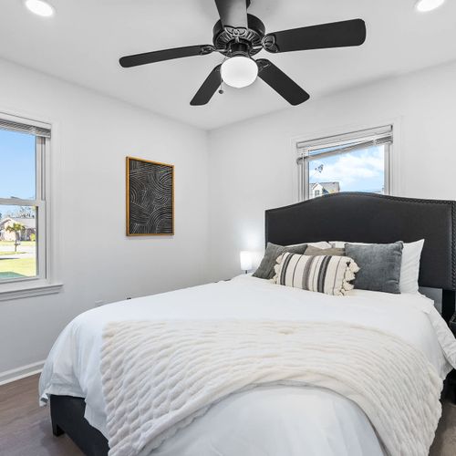 Wake up refreshed in this elegant bedroom 1, featuring cozy linens, chic decor, and sunlit views.