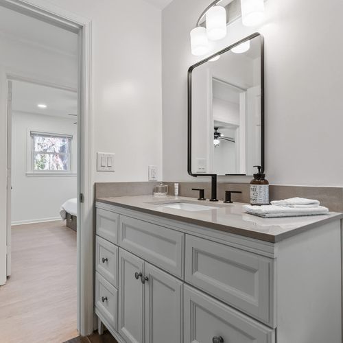 Chic ensuite with modern lighting, ample storage, and a sleek vanity — your private retreat awaits!