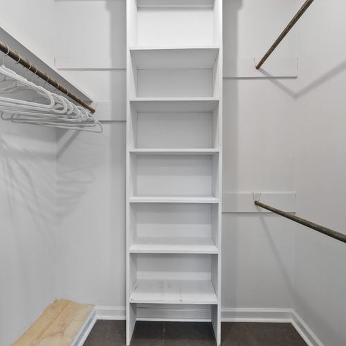 Spacious walk-in closet with built-in shelving — perfect for staying organized during your getaway!