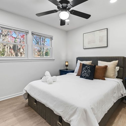 Relax in style with this cozy bedroom, featuring a plush bed, chic décor, and peaceful views.