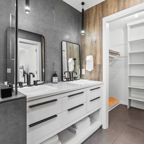 Modern ensuite with double vanity, sleek finishes, and a spacious walk-in closet — luxury meets convenience!